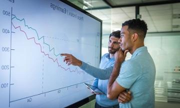two men analyzing business data
